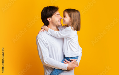 Warm portrait of cute little girl looking at her daddy