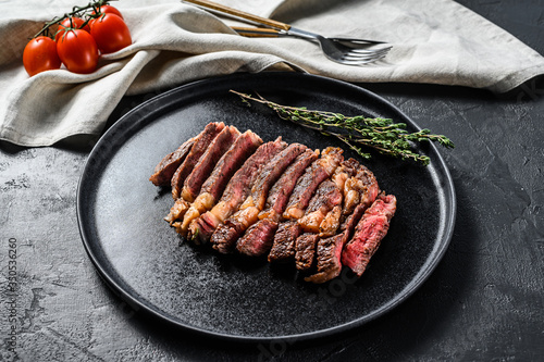 Grilled sliced Steak Rib eye with Pepper. black background. top view