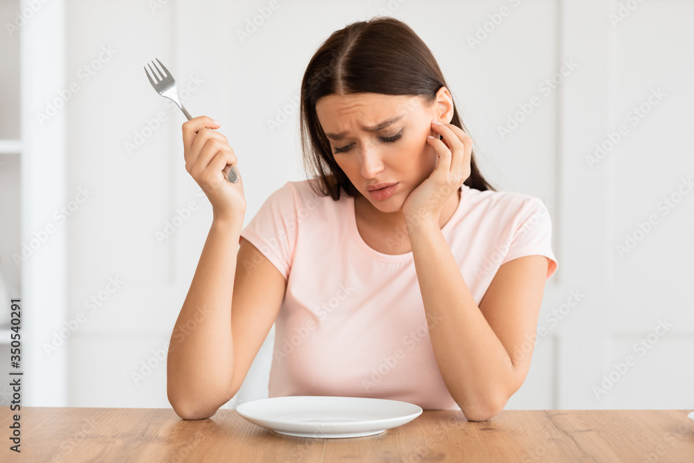 Hungry Woman Looking At Empty Plate Slimming At Home Hungry Woman Looking At Empty Plate Slimming At Home