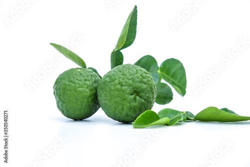 Citrus hystrix or Kaffir Lime is a citrus fruit native to tropical Asia, and green leaf isolated on white background © fridayimages
