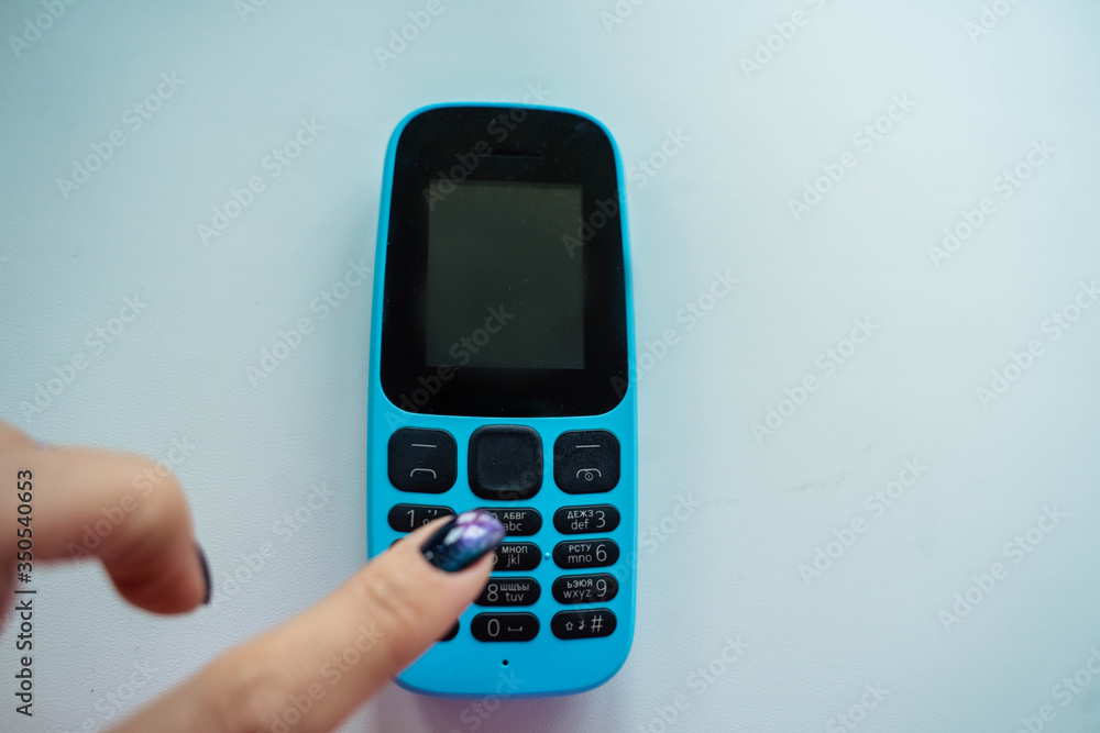 blue push-button cell phone with black buttons blue push-button cell phone with black buttons
