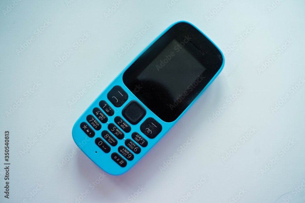 blue push-button cell phone with black buttons blue push-button cell phone with black buttons