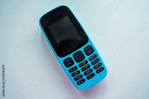 blue push-button cell phone with black buttons