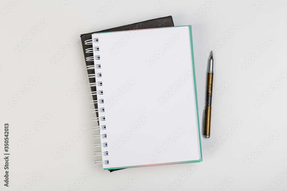 stack of colorful notebooks with pen isolated on white background stack of colorful notebooks with pen isolated on white background