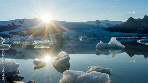 Fjallsarlon, Jokulsarlon glacier lagoon in Iceland during blue hour and sunset. Wanderlust and holiday concept.