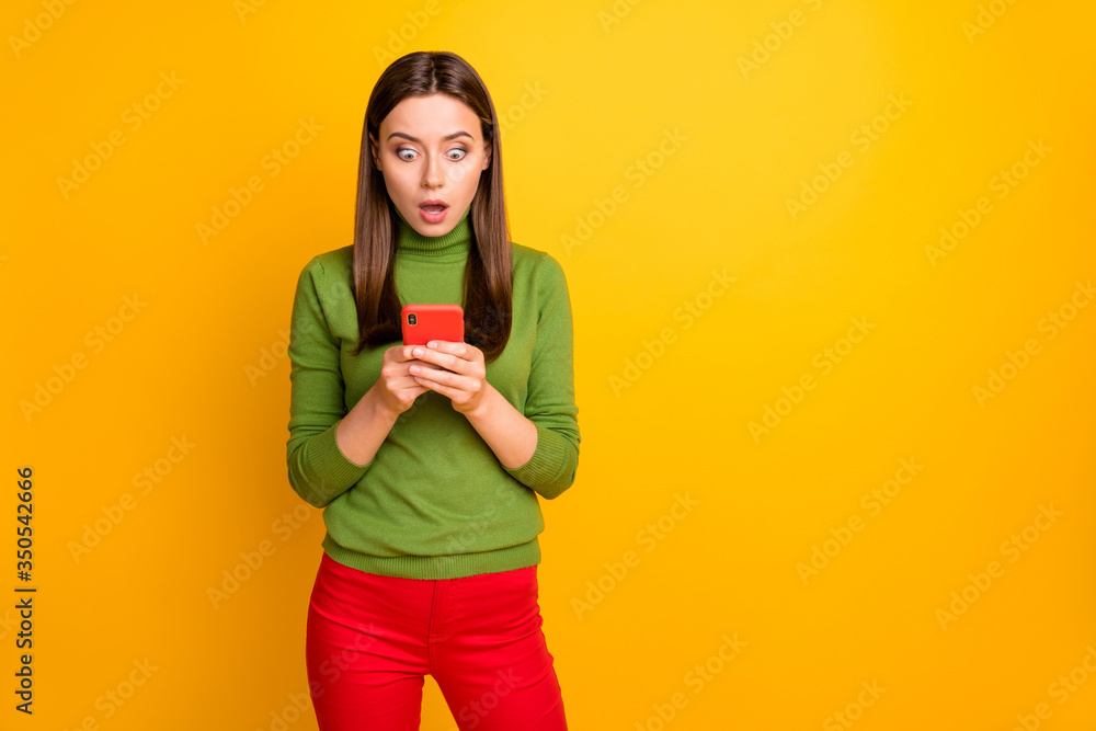 Portrait of crazy astonished girl use her smartphone read social network blog posts stay stupor scream unbelievable wear casual style clothing isolated over bright color background Portrait of crazy astonished girl use her smartphone read social network blog posts stay stupor scream unbelievable wear casual style clothing isolated over bright color background