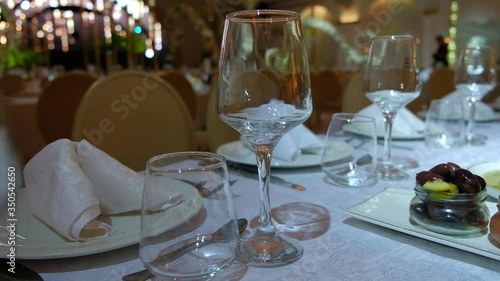 Elegantly made empty dinner tables in a chic restaurant shot with a slider.