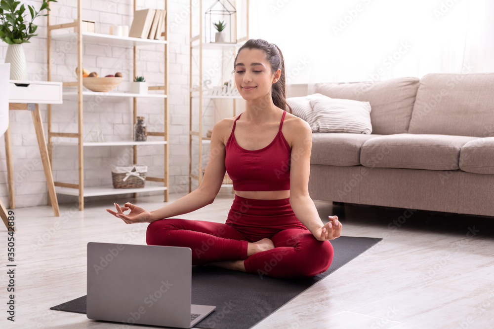 Meditation teacher leading online practice on laptop at home