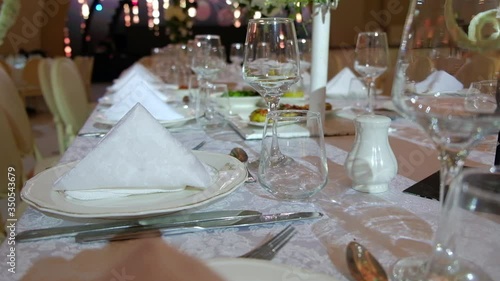 Elegantly made empty dinner tables in a chic restaurant shot with a slider.