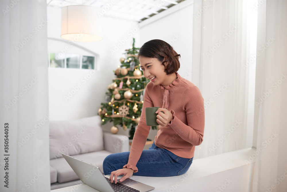Asian woman using laptop at home Asian woman using laptop at home