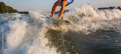 Photography Man surfing on the Surfboard pulled by a motor boat over the boat wave Wakeboard