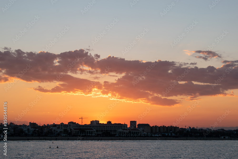 Bright evening sun setting over the city