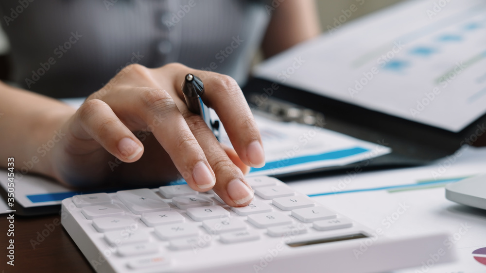 Αυτοκόλλητο Close up accountant banker or bookkeeper making calculations with calculator