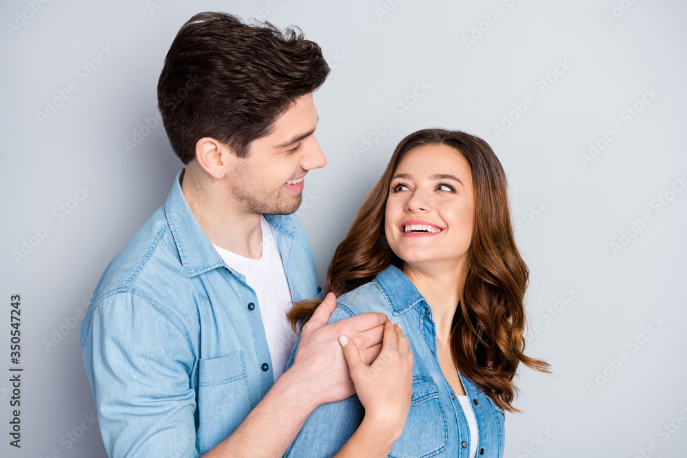 Portrait of positive passionate coupe student hug embrace cuddle enjoy togetherness look good enjoy wear casual style clothes isolated over gray color background Portrait of positive passionate coupe student hug embrace cuddle enjoy togetherness look good enjoy wear casual style clothes isolated over gray color background