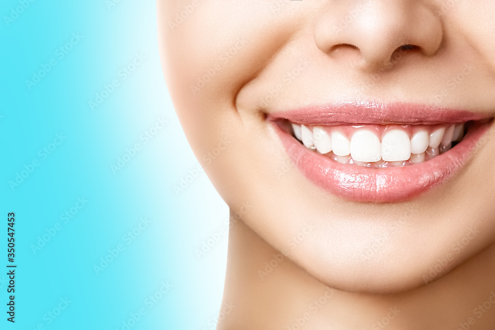 Obraz premium Beautiful female smile after teeth whitening procedure. Dental care. Dentistry concept