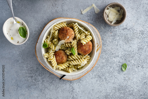 Pasta with pesto and meatballs. Copy space.
