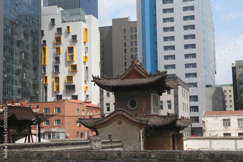 View of Ulaanbaatar city, Mongolia. Ancient and modern architecture together. Building facade of Choijin Lama Temple Museum. Ulaanbaatar landmark, architectural monument, sight, attraction, cityscape photo