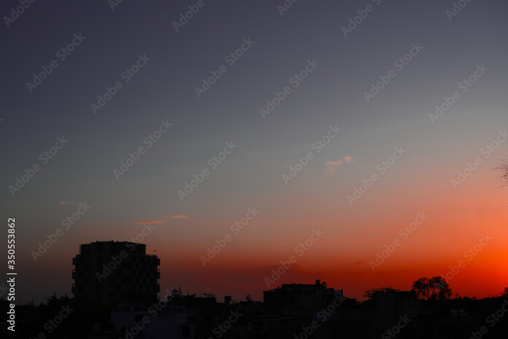Beautiful sunset view from rooftop displaying eye catching red and dark blue colour