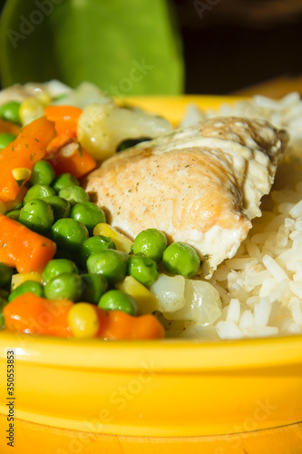 Close Up of a colorful healthy dinner with fish, rice and vegetables