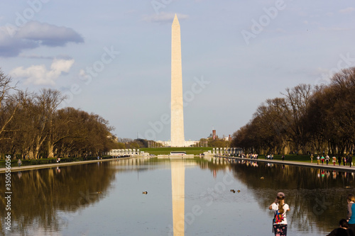 Spring view of the America's national monument, the Washington Monument reflecting on the surface of the Reflecting Pool, National Mall, Washington DC