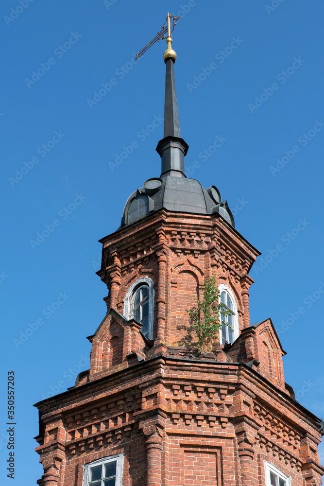 Corner tower of Volokolamsky Kremlin with the symbol of the city on the top of the steeple. Volokolamsk, Moscow Oblast, Russia..