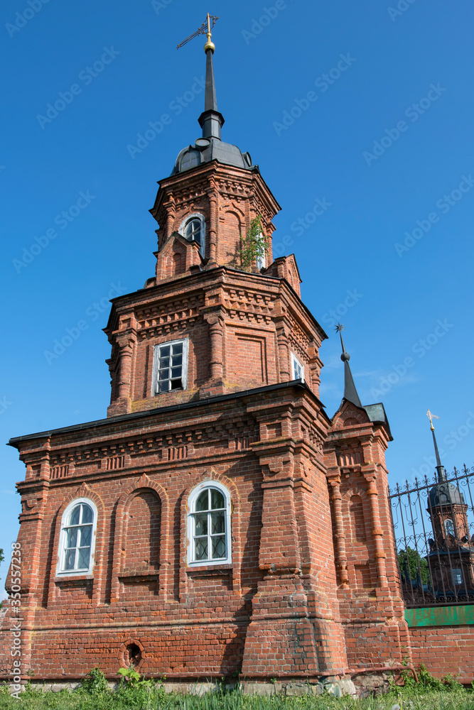 Fototapeta premium Corner tower of Volokolamsky Kremlin with the symbol of the city on the top of the steeple. Volokolamsk, Moscow Oblast, Russia..