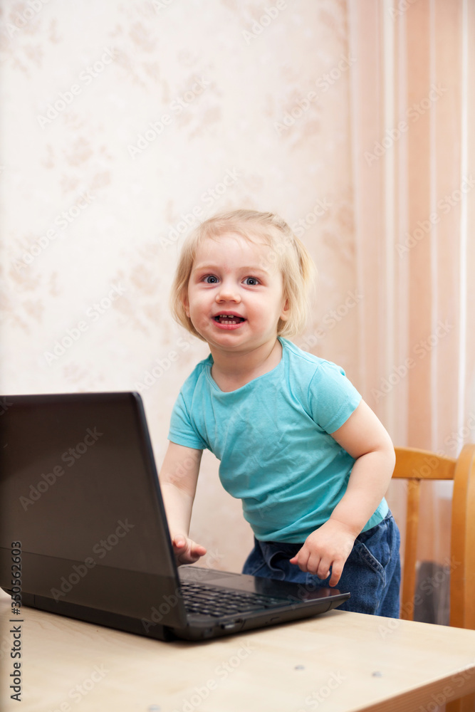 Portrait of small child with laptop at home Portrait of small child with laptop at home