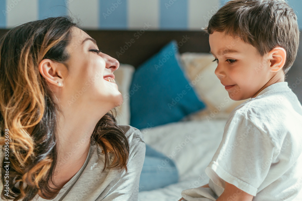 cheerful mother looking at cute toddler son cheerful mother looking at cute toddler son