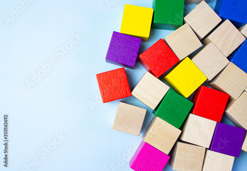 Colorful wooden building blocks for children on a blue blackground.