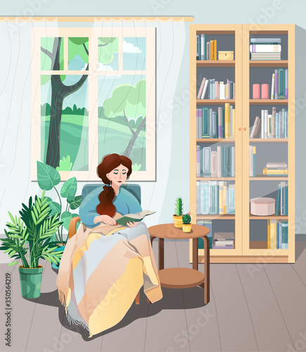 A young pretty girl is sitting in a comfortable chair under a plaid and reading a book. Summer landscape outside the window. A large bookcase and houseplants are nearby. Vector illustration.