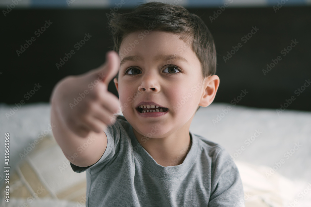 selective focus of cute toddler boy pointing with finger and looking at camera at home selective focus of cute toddler boy pointing with finger and looking at camera at home