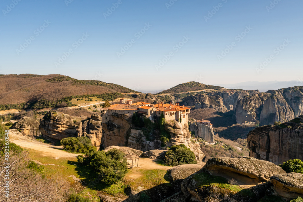 Sunshine on historical monastery on rock formations in meteora