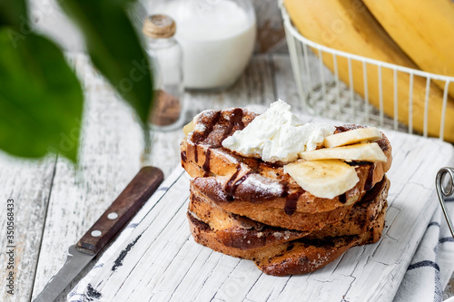 Toast with banana and curd cheese. A simple idea for breakfast. photo