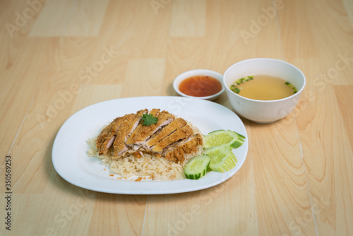 Fried chicken with rice. Thai Style Hainan Chicken. on The wood table.