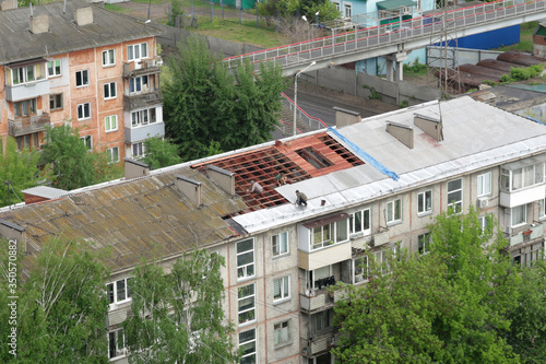 Repair work on the old roof of the house. Workers change the roof and lay slate