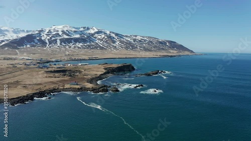 The beautiful blue waves by the Borgafjordur Eystri Harbor Town in East Iceland - aerial photo