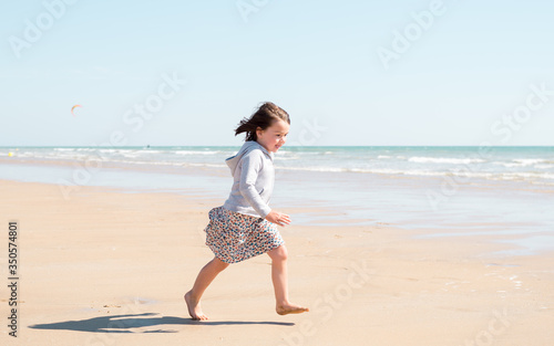 Young girl enjoying the beach on a beautiful sunny day