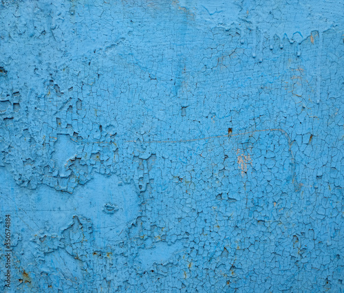 Blue old surface with cracked paint. Grunge abstract texture background