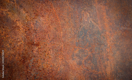 The background image of the iron sheet is rusting caused by prolonged use.Close up of black rust on an old sheet of metal texture.