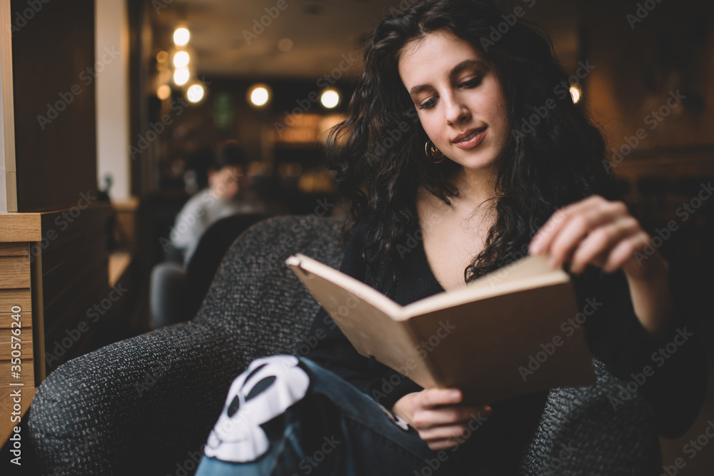 Young woman sitting with book in cafe Young woman sitting with book in cafe