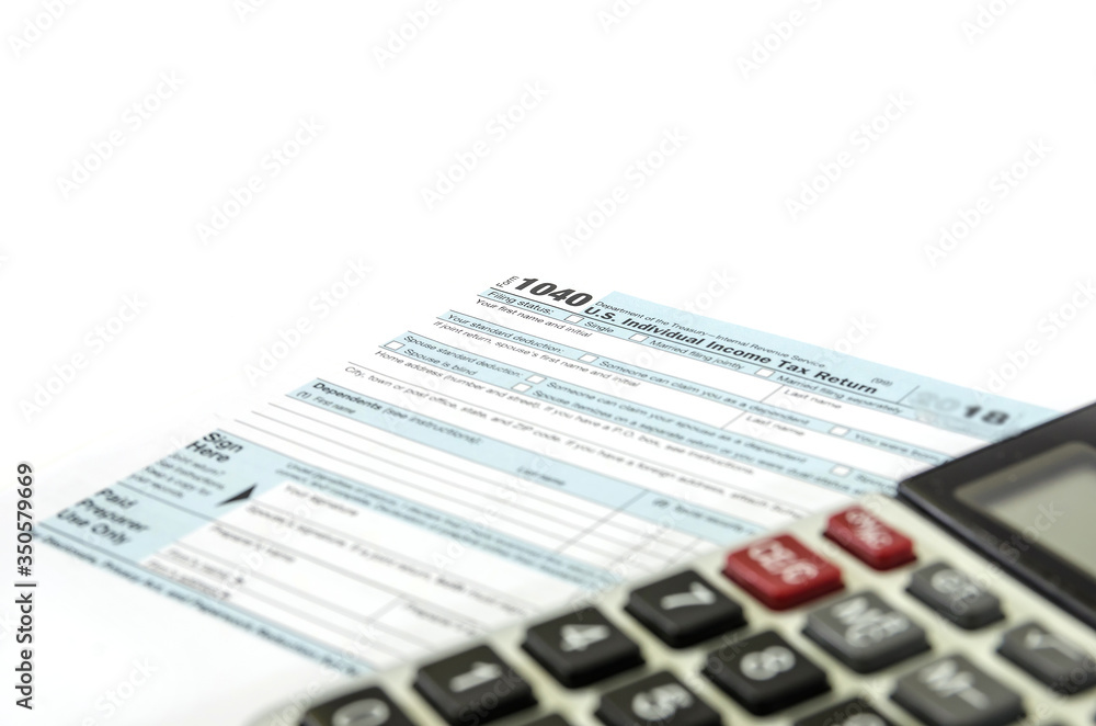 tax form 1040 and part of the calculator on white. Financial document. tax form 1040 and part of the calculator on white. Financial document.