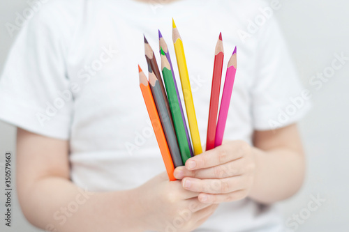 The child holds pencils in his hands. Children's development. Selective focus