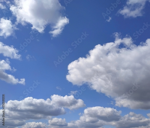 White cumulus clouds on blue sky background