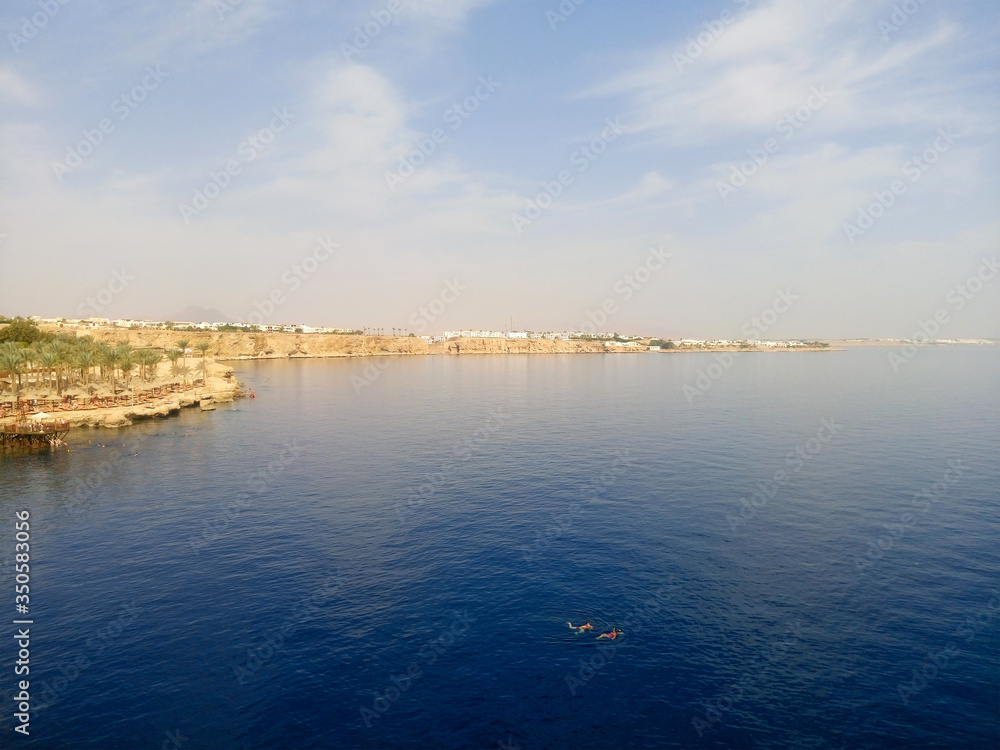 Fototapeta premium View of the Red Sea and the beach. Sharm el Sheikh at the southern tip of the Sinai Peninsula on the Red Sea coast of the Egyptian Riviera.
