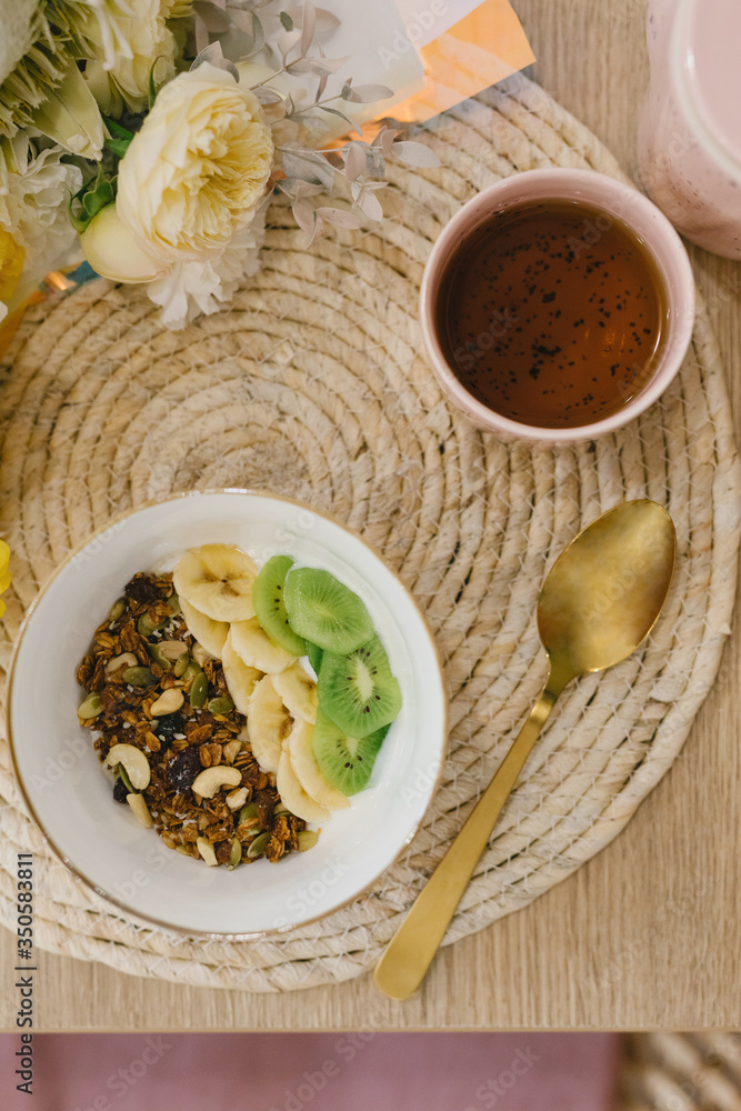 Tasty and healthy breakfast in the cafe. Granola in a pink bowl. Flat lay. Coffee shop concept. Tasty and healthy breakfast in the cafe. Granola in a pink bowl. Flat lay. Coffee shop concept.