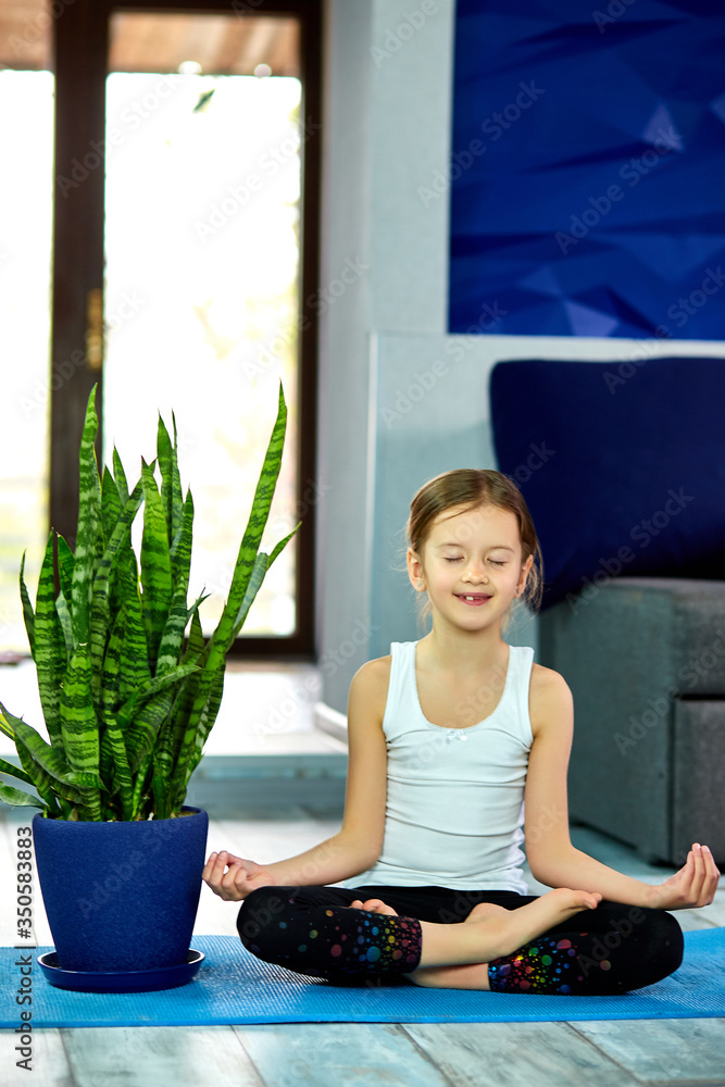 Little girl meditating in lotus pose with closed eyes Little girl meditating in lotus pose with closed eyes