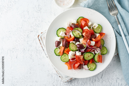 Greek village salad horiatiki with feta cheese, olives, cherry tomato, cucumber and red onion