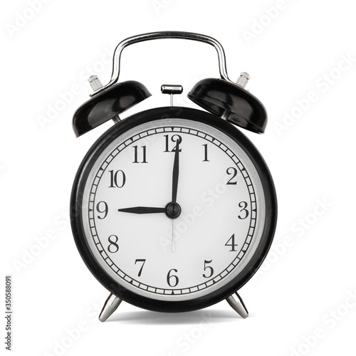 Classic round black metal alarm clock isolated on white background. 9 o'clock