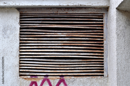 ventilation hole in concrete. Metal industrial square ventilation cover.