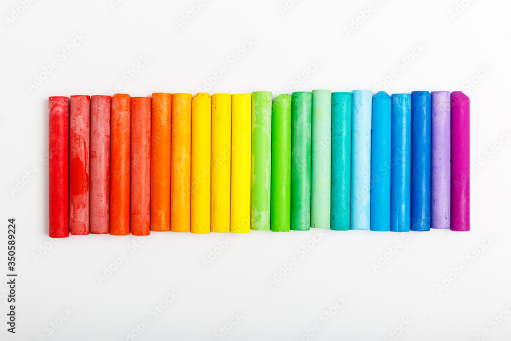 multi-colored pastel on a white background. concept of drawing school or art store. colors of rainbow. multi-colored pastel on a white background. concept of drawing school or art store. colors of rainbow.